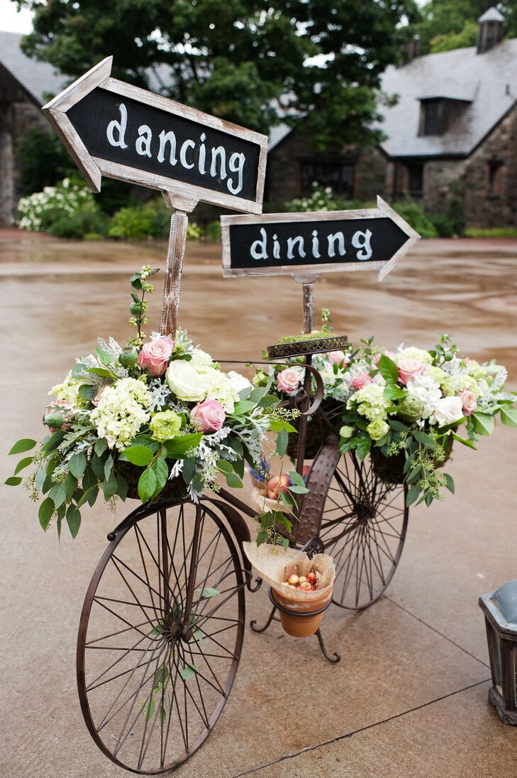As an adorable décor addition, a metal bicycle decked out with flowers and chalkboard signs directed guests to the dinner and dancing.