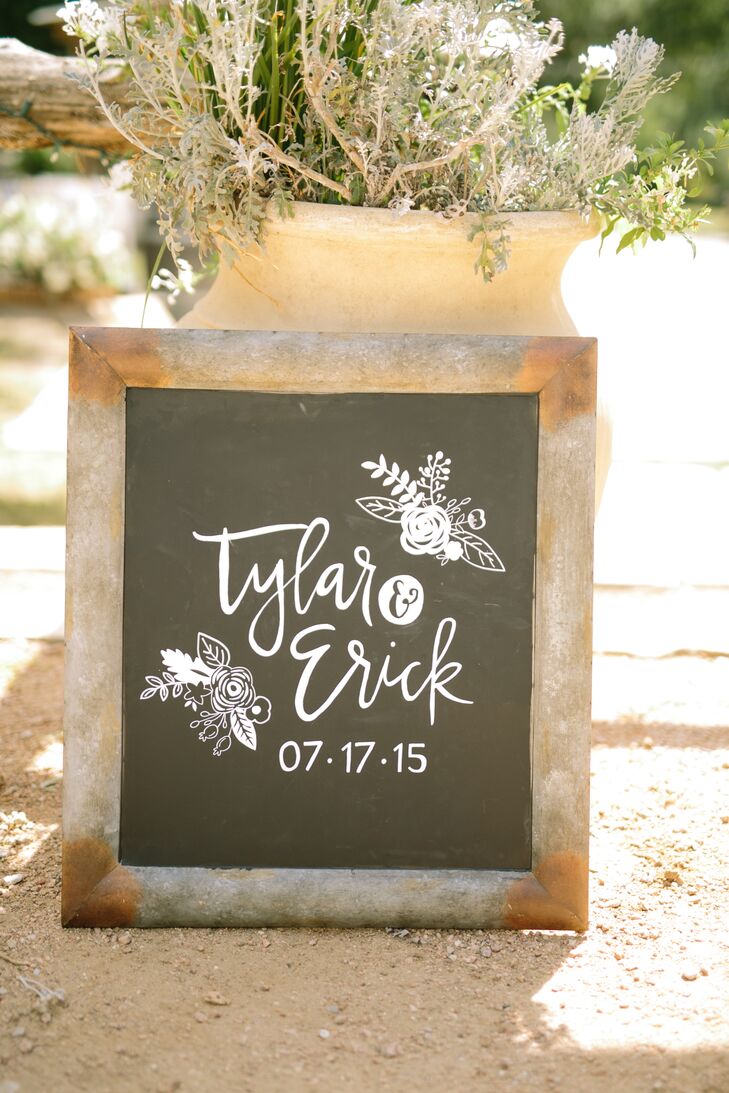 Custom calligraphy by Frou Studio added a whimsical touch to the decor around Tylar and Erick's vintage-inspired outdoor wedding at Cedar Bend Events in Cedar Creek, Texas.