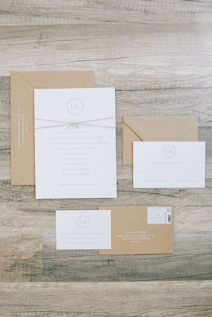 "Our custom-made letterpress invitations from Sugar Paper were simple and contemporary, with clean fonts in pale blue on crisp white stationery," Leah says. "We designed our own monogram which was included on the invitations, the programs, and was painted on our distressed wood aisle treatment. We finished off the invitations with a small piece of twine to tie in the sand element of our wedding day."