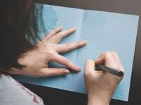 Woman writing in card.