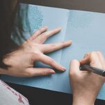 Woman writing in card.