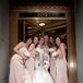 Kelly’s nine-foot train was manned by five bridesmaids dressed in silk charmeuse blush gowns. Silk ivory satin ribbons were tied at the waist of each bridesmaid.