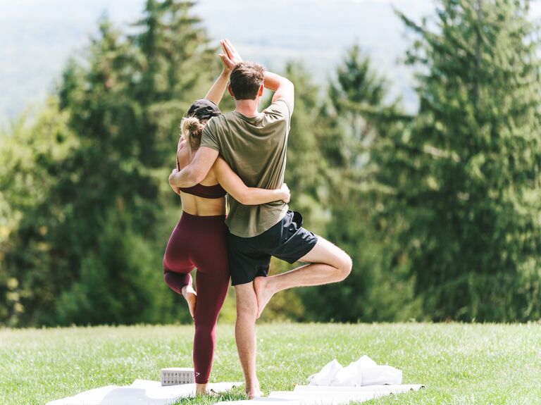 Couple doing mountaintop yoga