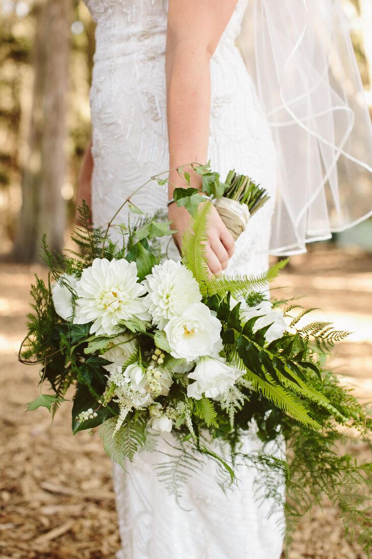 Hailey held an ivory bouquet filled with roses and chrysanthemums accented with fern and other greenery. Hailey had a love for fern, so it wasn't uncommon to see the leaves in many, if not all, of the flower arrangements throughout the wedding day decor.