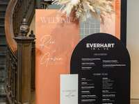 Colorful wedding hashtag sign on seating chart at reception