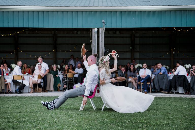 Newlywed couple playing the wedding shoe game