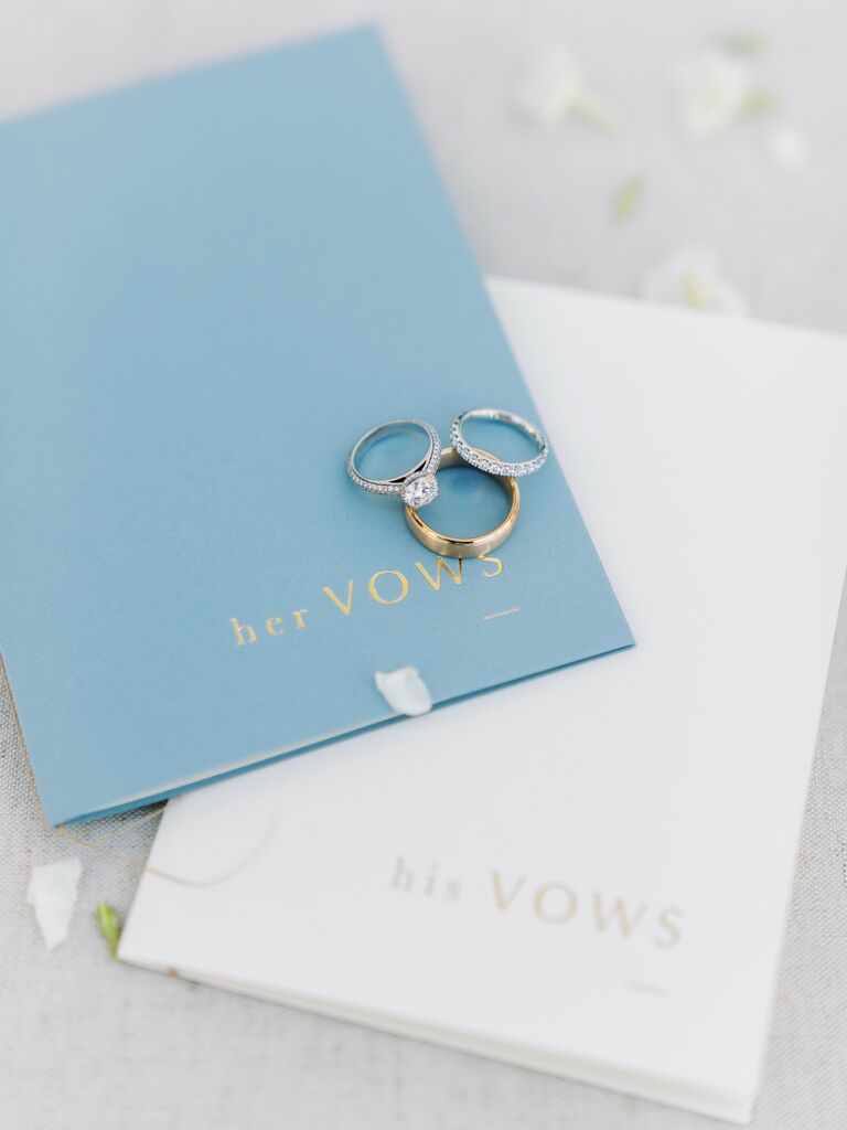 light blue vow booklet embossed with "her vows" in gold lettering