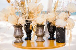 Boho-Chic Seating Display on Mixed-Metal Vases at Beach Wedding