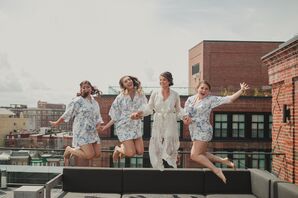Bride and Bridesmaids in Robes Jumping on Rooftop at The Line Hotel in Washington, DC