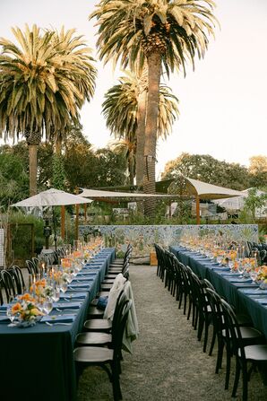 Garden Reception With Long Tables, Blue Linen and Orange Centerpieces