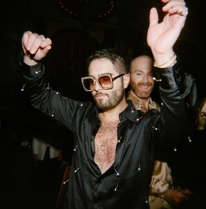 Groom in Disco Attire and Sunglasses Dancing During Reception