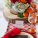 The couple's red and blue gingham table runner gave the woodland-themed centerpieces a lumberjack feel.