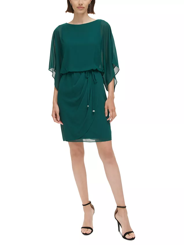Model wearing an emerald dress with flowing sleeves and a waist tie