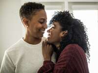 Couple hugging each other at home.