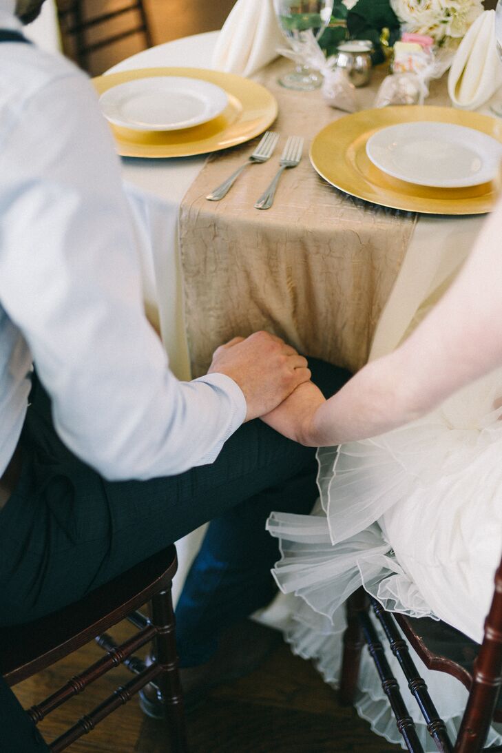 Newlyweds Holding Hands Under the Table