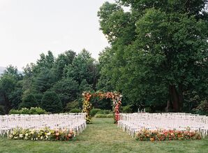 Colorful Outdoor Ceremony Space in Garden With Lush Floral Arch