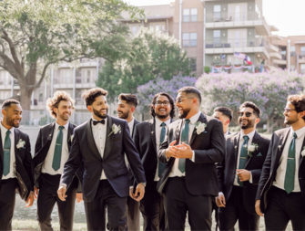 Groomsmen smiling with each other on wedding day