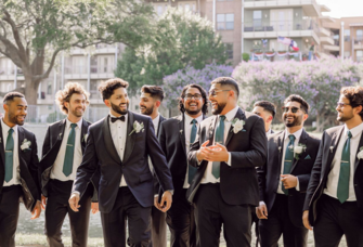 Groomsmen smiling with each other on wedding day