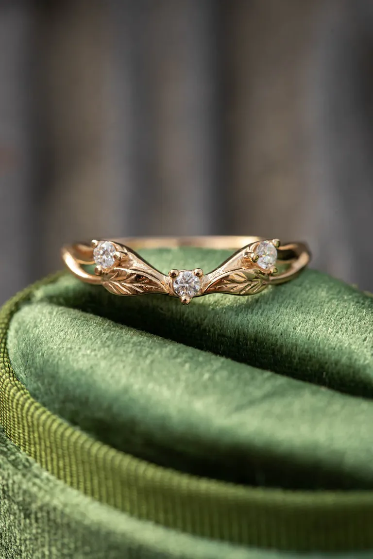 curved ring with three diamonds and leaf motifs
