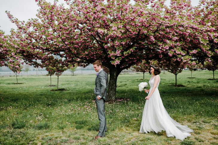 Since Janel and Charlie love the outdoors, it was fitting that they shared their first look among the trees. He waited by the gorgeous cherry blossoms at the Liberty House Restaurant in Jersey City, New Jersey, as Janel walked up to tap his shoulder.