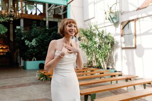 Bride in Fitted Gown, Shoer Hairstyle Smiling at Her Industrial-and-Garden Ceremony Before Wedding