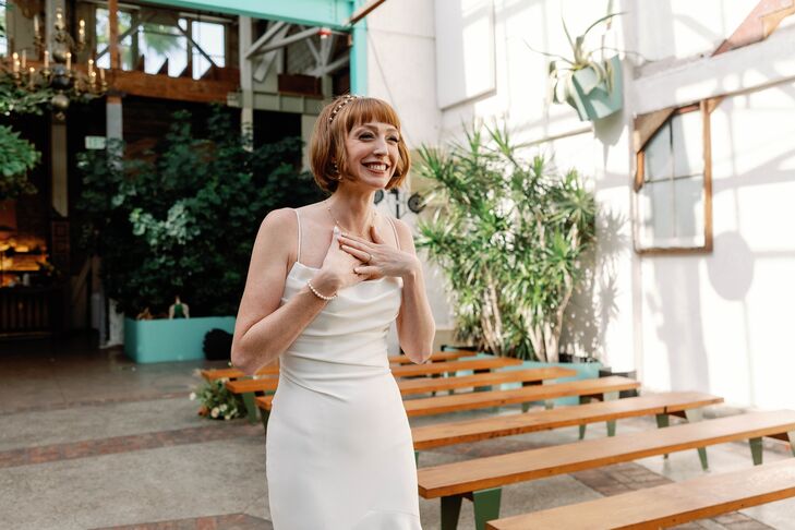 Bride in Fitted Gown, Shoer Hairstyle Smiling at Her Industrial-and-Garden Ceremony Before Wedding