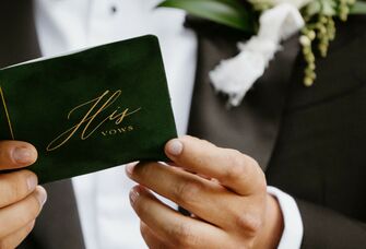 Groom holding vows