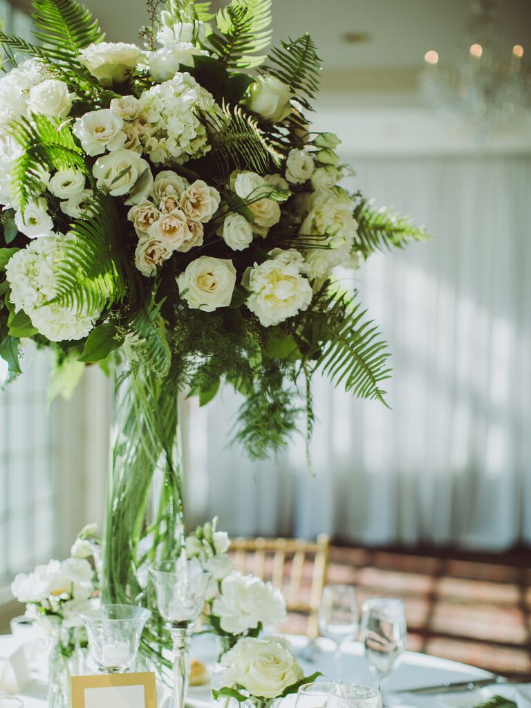 classic tall wedding centerpiece with white and blush roses and fern leaves