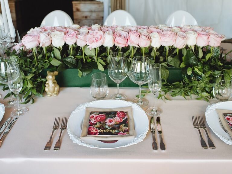 An orderly row of pink roses.