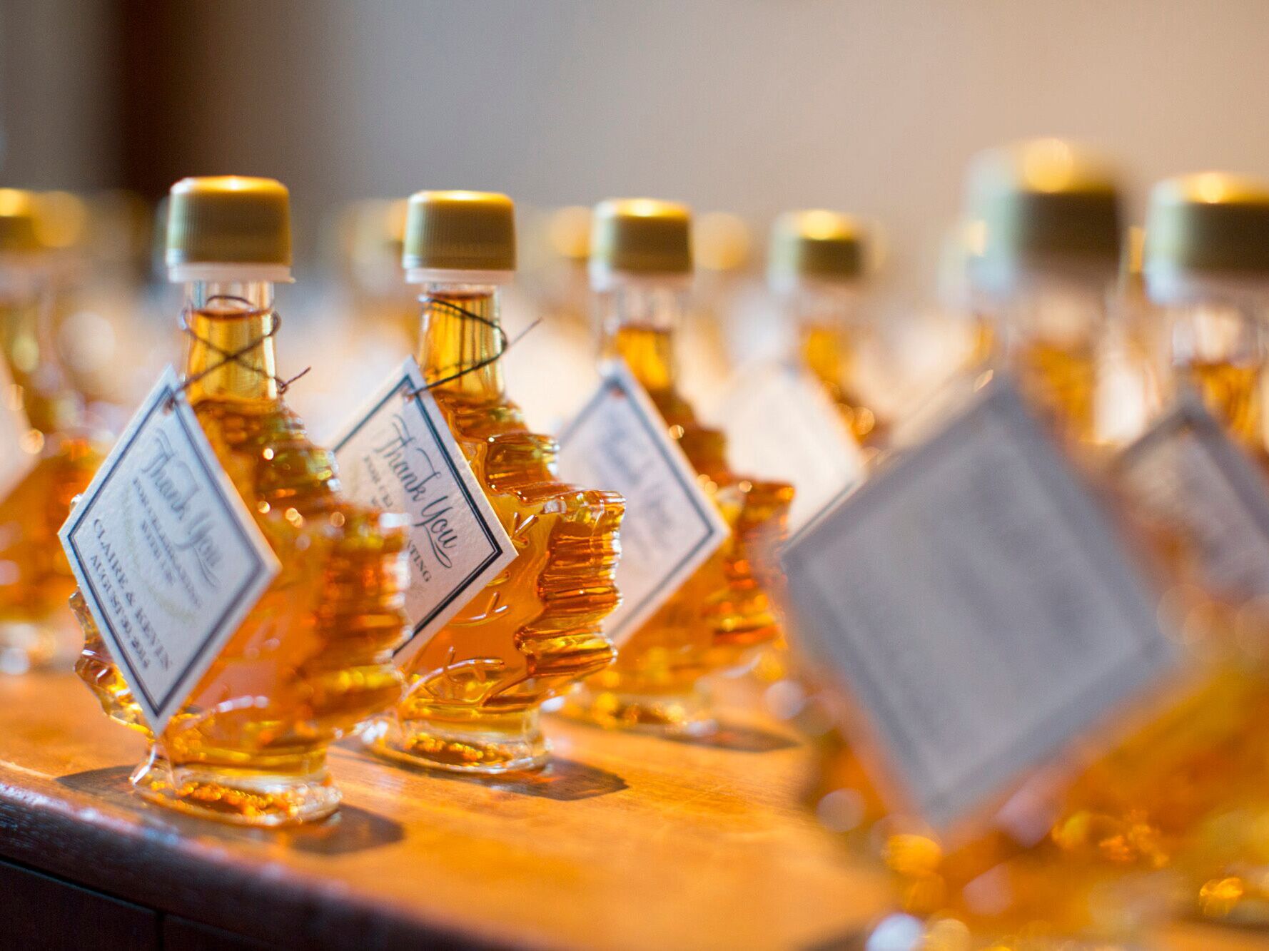 Fall wedding favors maple leaf syrup bottles with personalized gift tags
