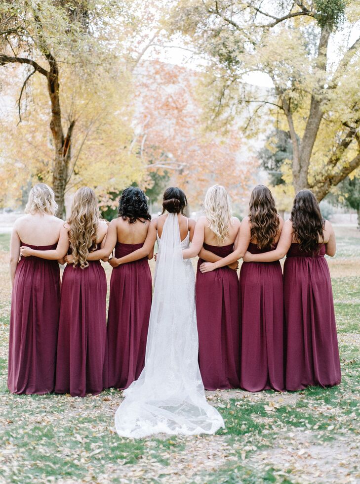 For her bridesmaids, Danika chose long, deep wine-hued gowns. The look fit well with the rustic, wintertime wedding.