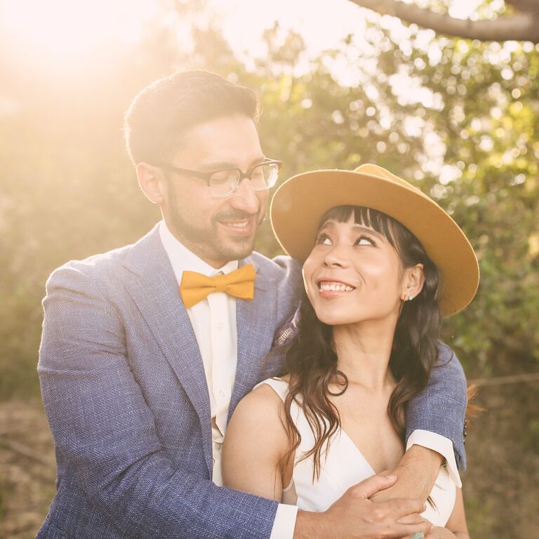 Sunlit outdoors engagement photo with hat