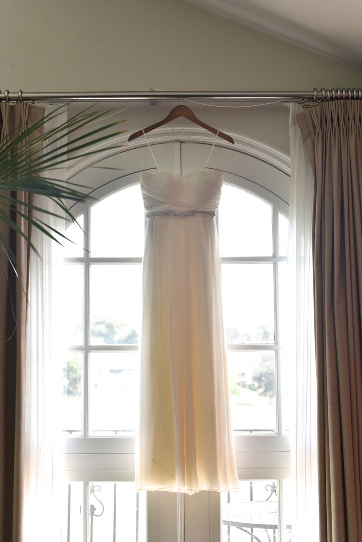 Julie wore an ivory strapless wedding dress made of chiffon and silk, which had a wrapped pattern on the chest of the bodice accented with a thin crystal belt. Her bridesmaids wore similar dresses, which were all designed and purchased from J.Crew.