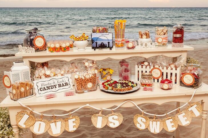 A candy bar added a sweet touch to Marta and Jose Luis's reception at Le Reve Hotel and Spa in Playa del Carmen, Mexico. They offered a variety of treats and snacks for their guests, labeled with their custom monogram.
