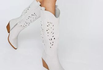 Stylish white cowboy boots with intricate detailing. 