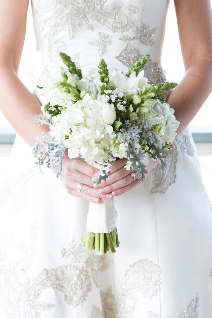 The wedding flowers were all white to maintain the classic style. Leigh carried a wintery bouquet of white hydrangea with dusty miller.