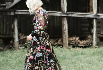 Bride in a funky black dress shows off a stylish platinum blonde bob. 