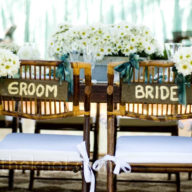 Courtney and Andrew sat in chairs marked specially for them with painted wooden signs and white daisies.