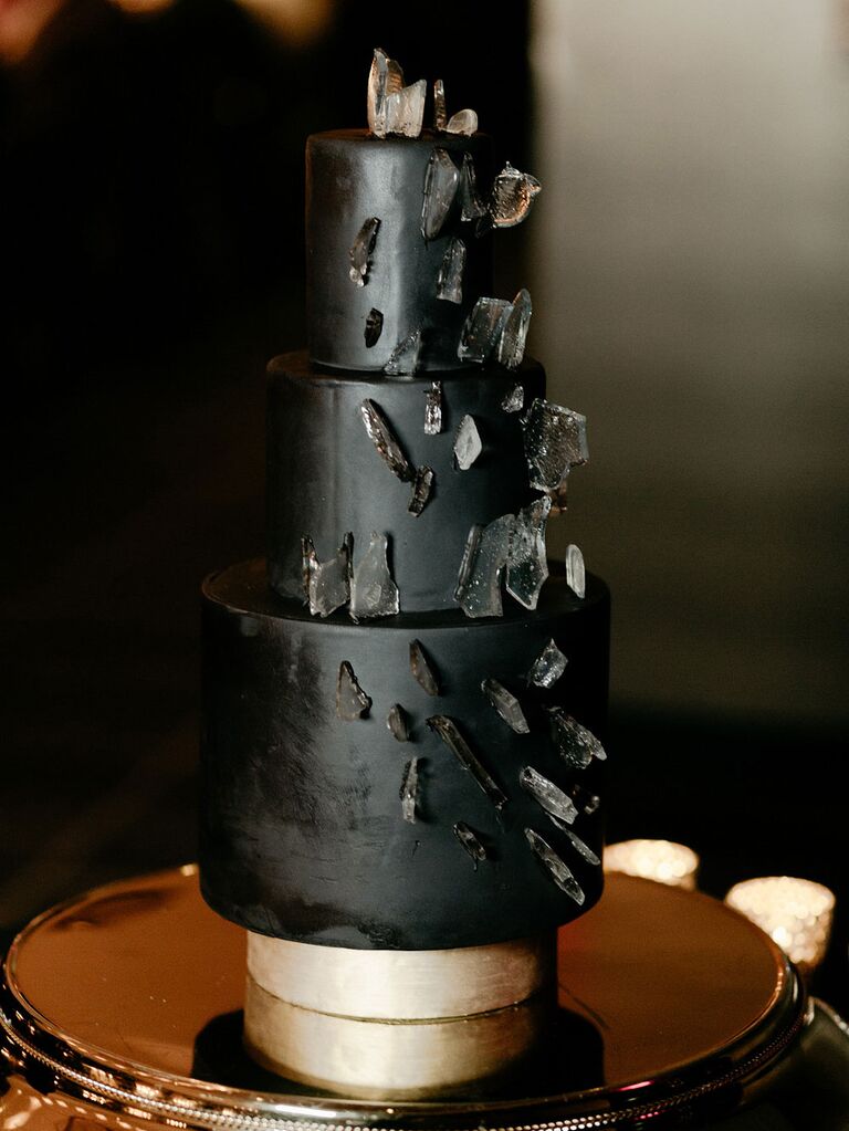Three-tier black wedding cake with geode decorations