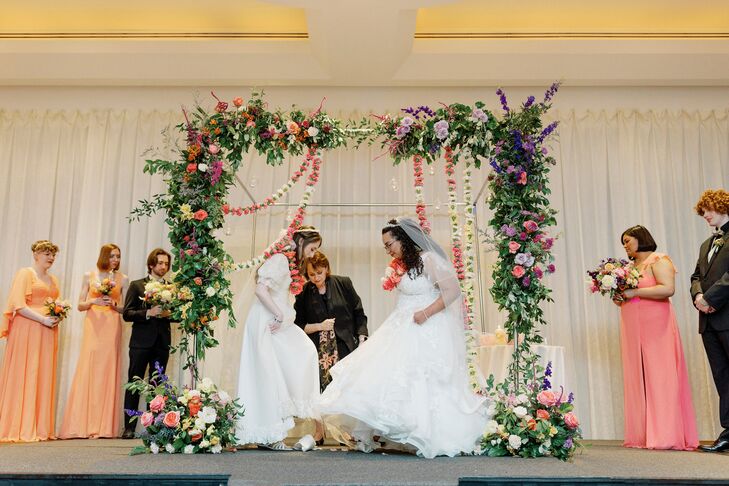 Brides Breaking the Glass Under Chuppah at Same-Sex Jewish Wedding Ceremony