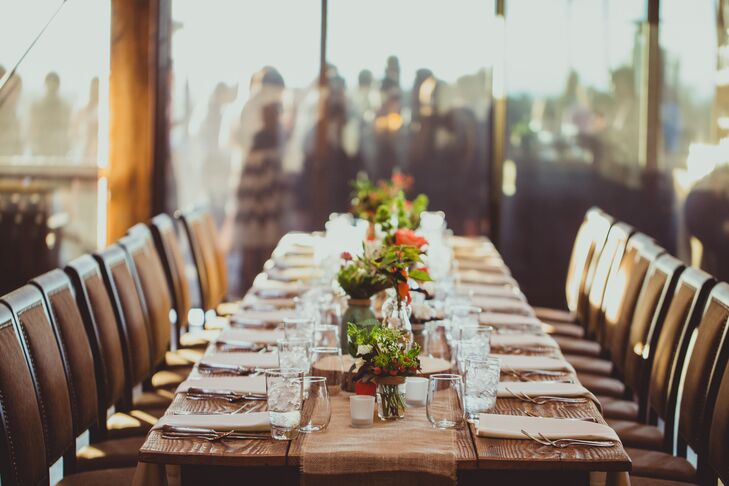 Wood dining tables were decorated with small plant and flower centerpieces down the middle.