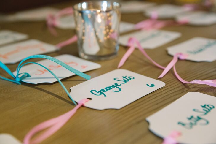 The names of each guest were handwritten on gift tags and tied with pink and teal ribbons.