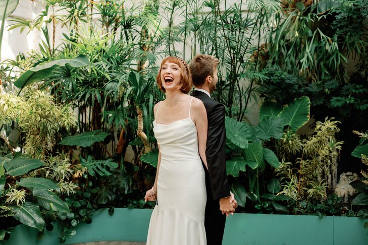 Bride and Groom Back-to-Back in Industrial Garden Space for a "No-Look First Look"