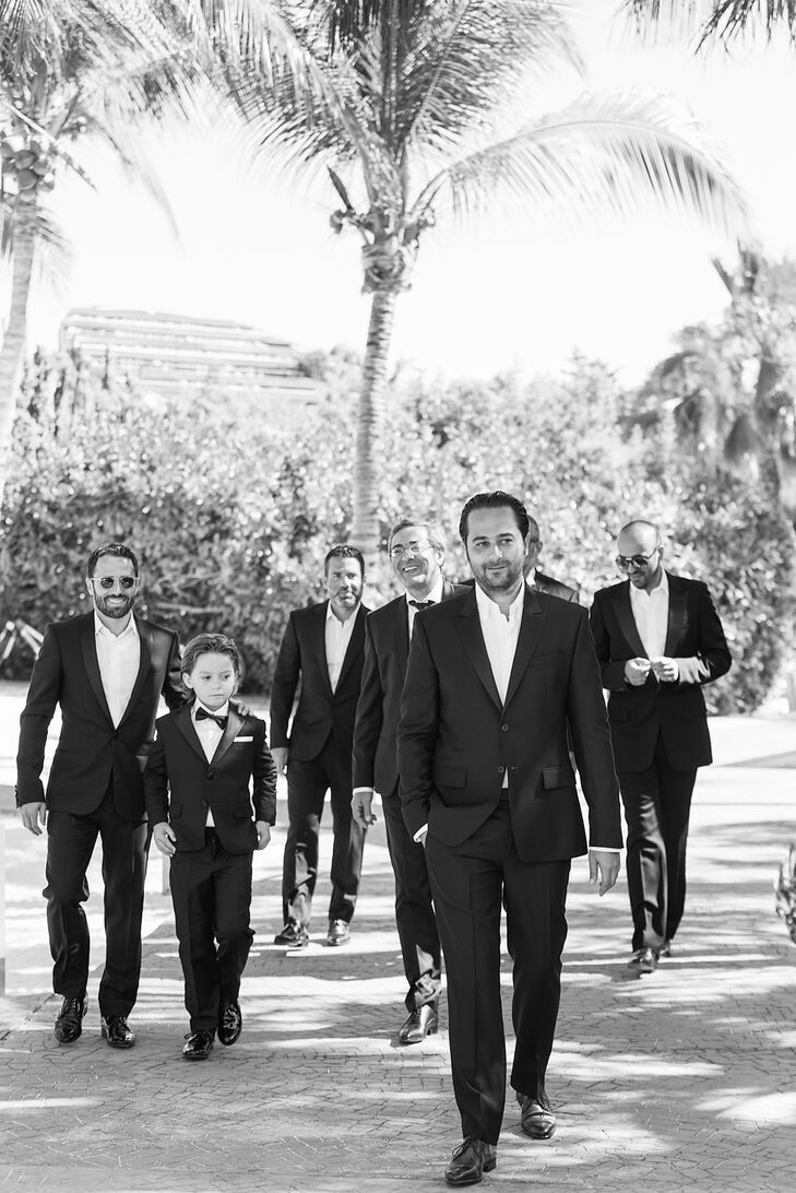 To match the elegant but simple beach ceremony,  Vincent and his groomsmen sported elegant black suits without ties.