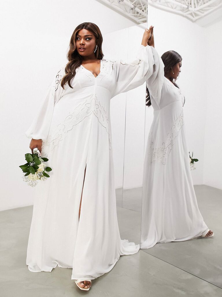 Model wears a long sleeved white dress with beautiful embellishments. 