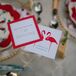 Colorful cards held guests' drinks as well as listing the official hashtag for social media photos of the wedding.