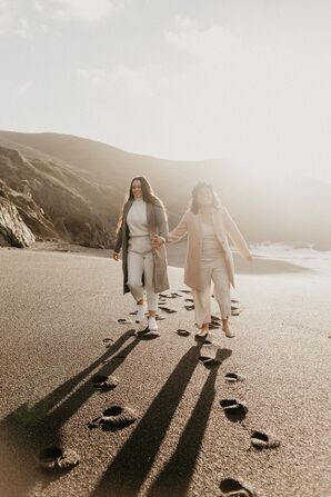Couple Walking Along the Beach at Sunrise