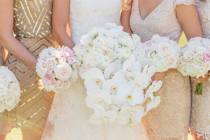 Megan took the traditional route when it came to her bouquet, working with Bella Flora to create a showstopping arrangement of all-white blooms. Roses and ranunculus offered the bouquet a romantic vibe, while cascades of white orchids brought the drama in a big way.