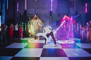 Bride in Jumpsuit and Groom Dancing, With a Dip, on Checkered Dance Floor