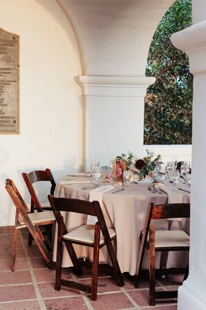 Simple Round Dining Table With Muted Linen, Wood Chairs and a Low Centerpiece